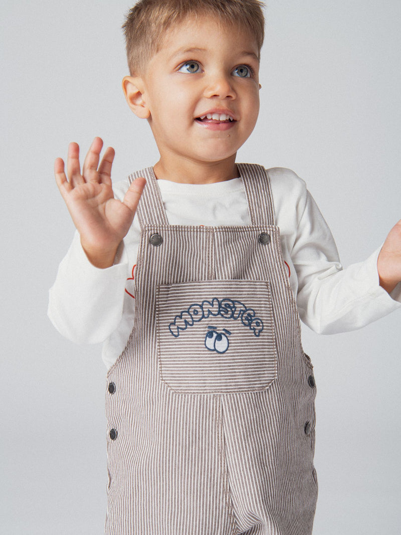Salopette a righe in denim cacao e ecru "Monster" per bambino