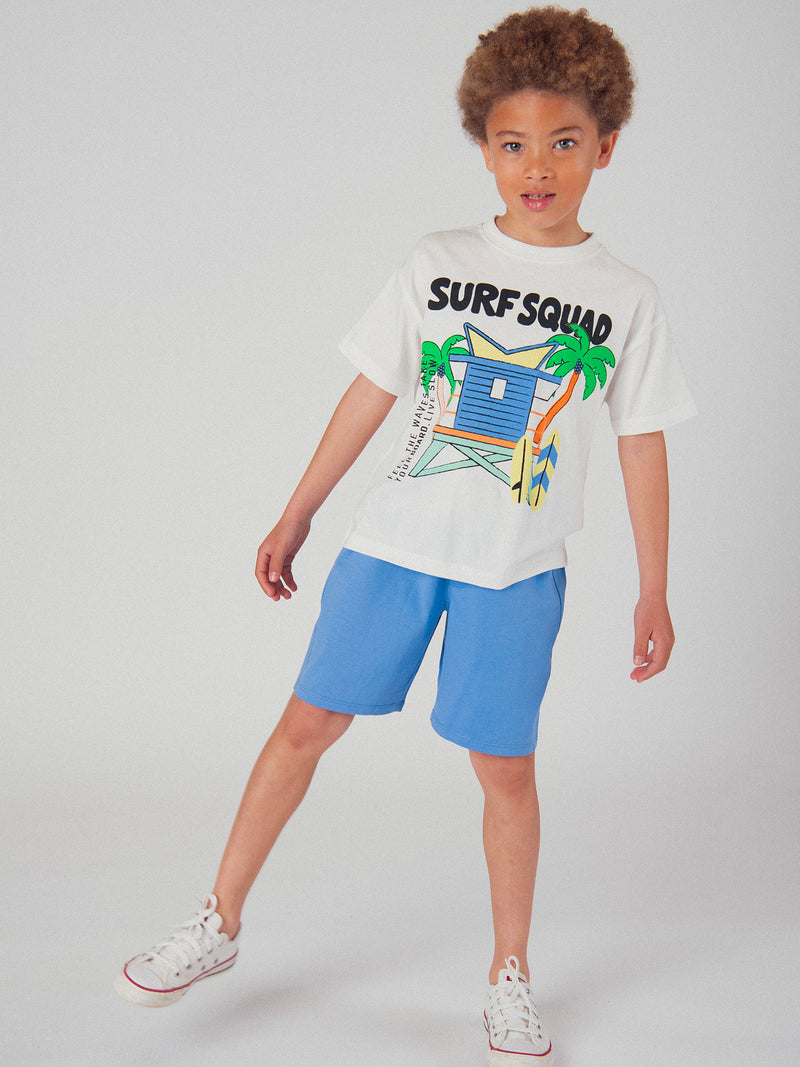 Completo di t-shirt écru e pantaloni corti blu con animazione per bambino