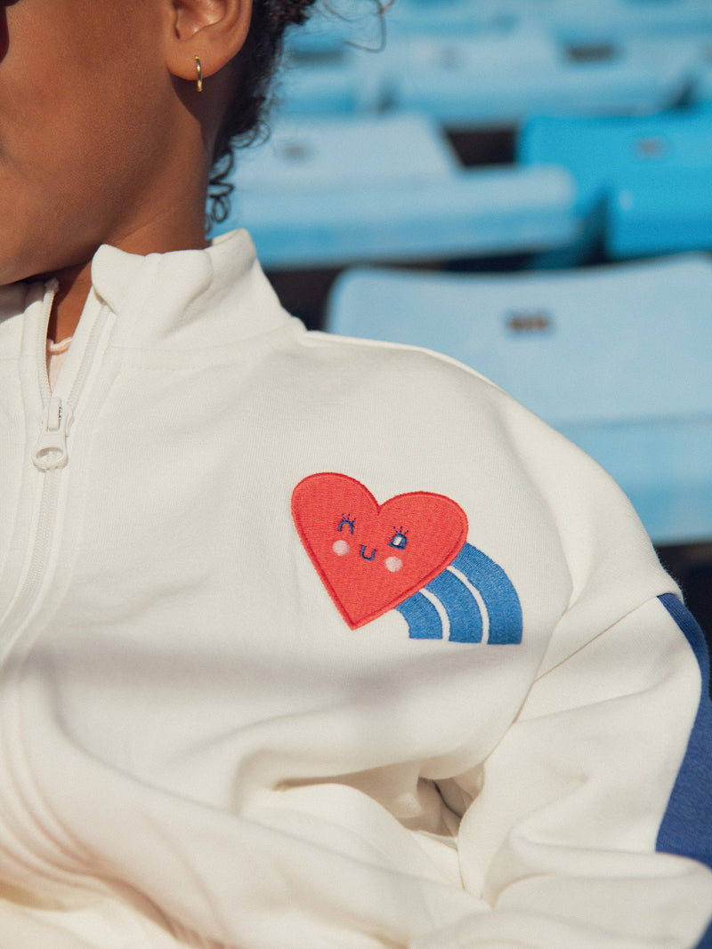 Cardigan ecru con zip e badge sul petto per ragazze