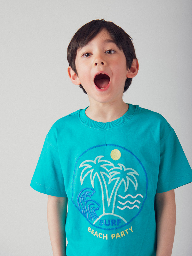 T-shirt blu turchese con animazione in spiaggia per bambino