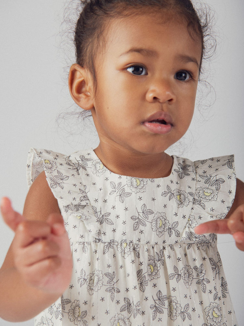 Abito floreale per bambina con spalle a volant e bloomer coordinato