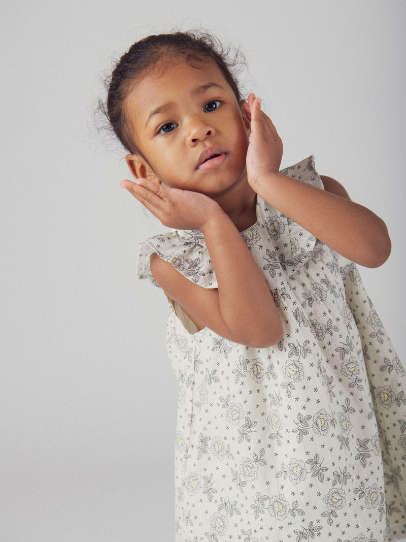 Abito floreale per bambina con spalle a volant e bloomer coordinato