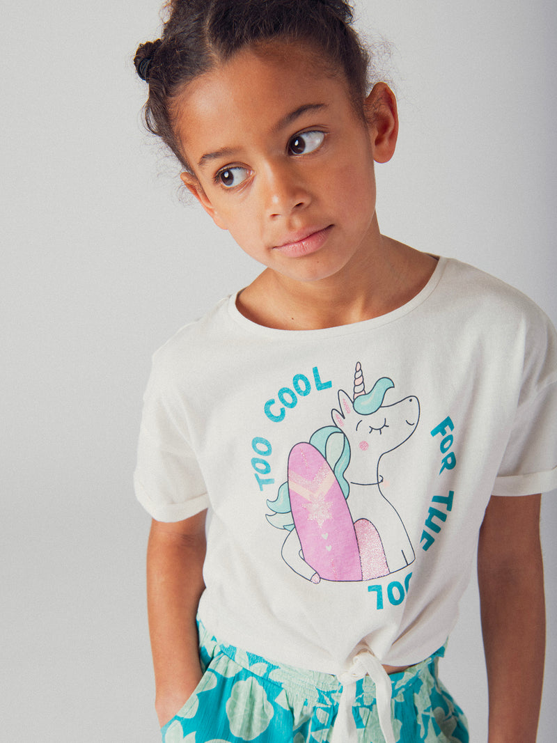 T-shirt ecru con animazione di unicorno e surf per ragazze
