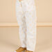 Pantaloni beige con stampa ciliegia